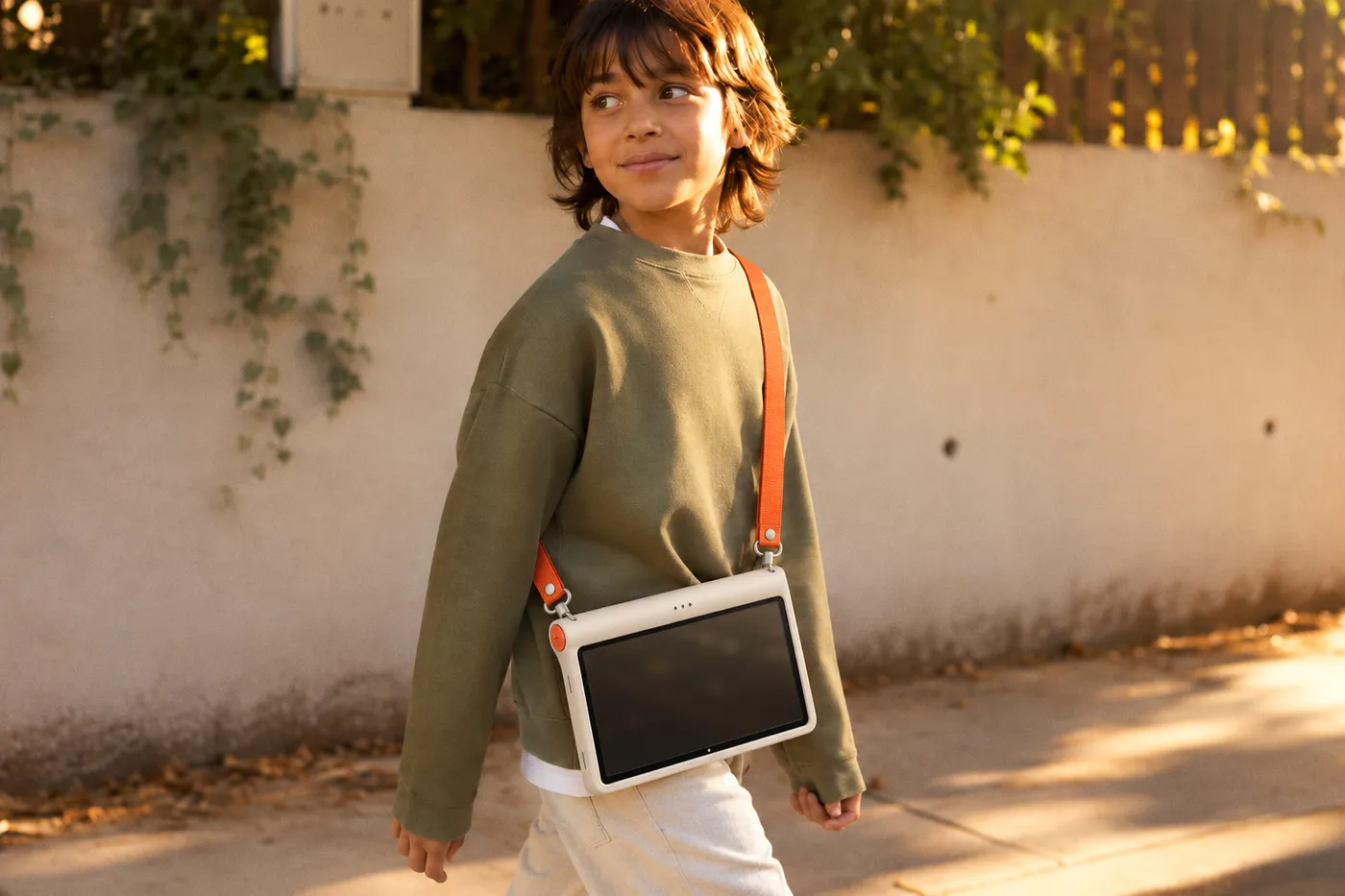 A kid carrying Kale on its strap